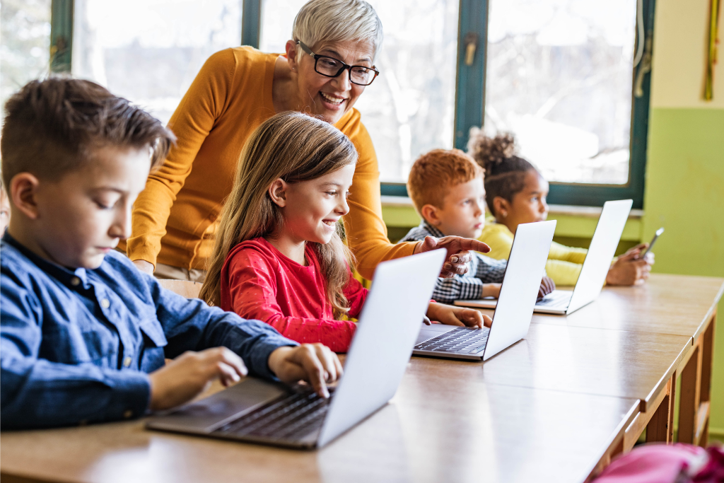 teacher with students on laptop